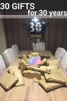 a table that has some bags on it and the words 30 gifts for 30 years above it