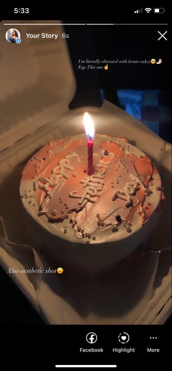 a birthday cake with a lit candle in it