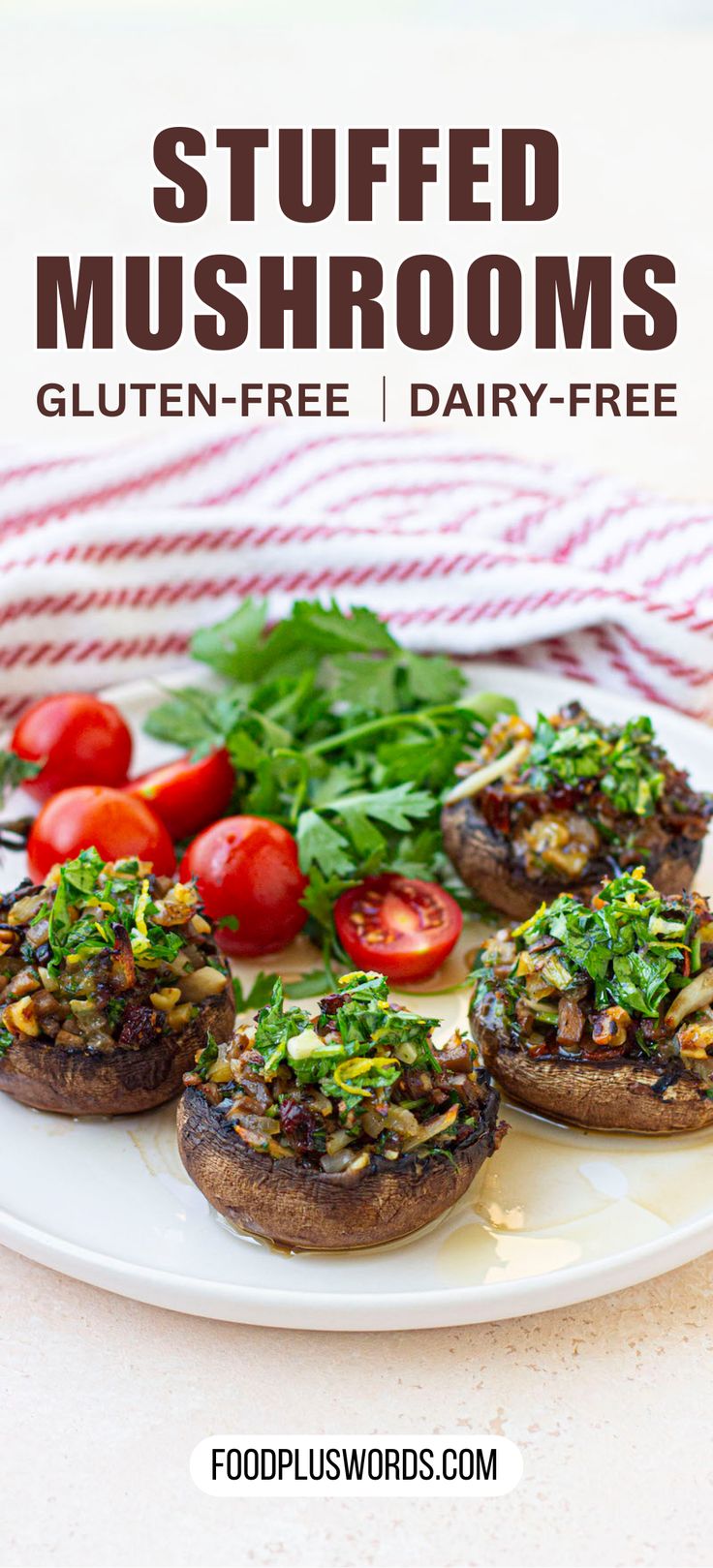 stuffed mushrooms on a white plate with tomatoes and parsley in the background text reads stuffed mushrooms gluten - free dairy - free