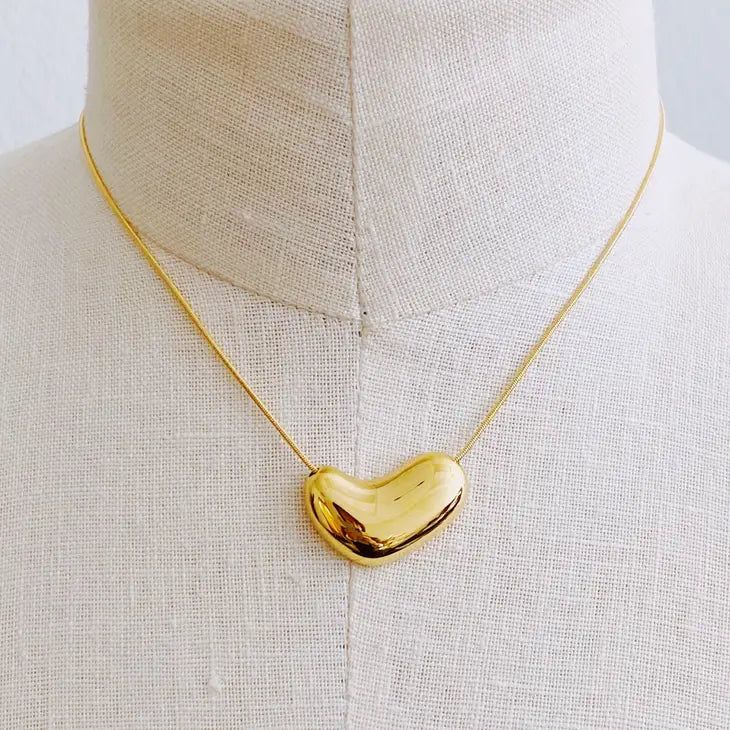 Add a touch of romance with our Molten Heart Necklace in Gold. This delicate necklace features a unique molten heart design that adds a playful twist to any outfit. Perfect for a flirty date night or as a heartfelt gift for a loved one. Shop more Necklaces Gold Molten heart Bold Herringbone chain 18k gold plated stainless steel Water and tarnish resistant Lead and nickel free Dimensions: approximately 16" with a 2" extender, heart pendant approximately 1.2" x 0.6" Herringbone Chain, Everyday Gifts, Gold Heart Necklace, Womens Watches Luxury, Silver Heart Necklace, Delicate Necklace, Steel Jewelry, Stainless Steel Jewelry, Hair Accessories Headbands