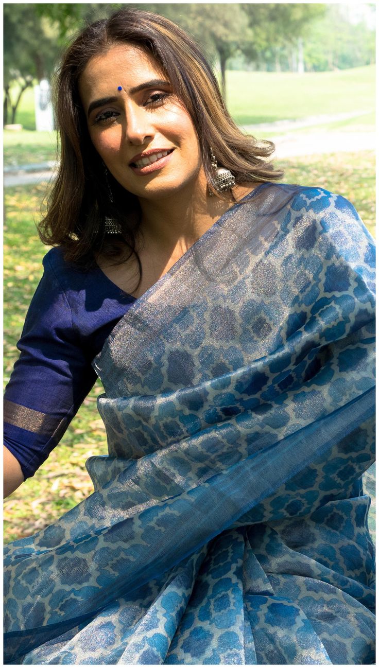 Pure Tissue Saree with fine silver zari linear design and morrocan motifs. It is paired up with Chiniya Silk Blue Blouse Piece. Color: Indigo, Light Blue and Silver.Ocassion: Fusion/ Casual/ Festive. Elegant Block Print Traditional Wear For Festive Occasions, Elegant Block Print Traditional Festive Wear, Elegant Festive Block Print Traditional Wear, Elegant Festive Traditional Wear With Block Print, Elegant Cotton Silk Blouse Piece With Motifs, Silver Banarasi Silk Blouse Piece, Festive Slub Silk Blouse Piece With Block Print, Silver Art Silk Blouse Piece, Tissue Silk Saree