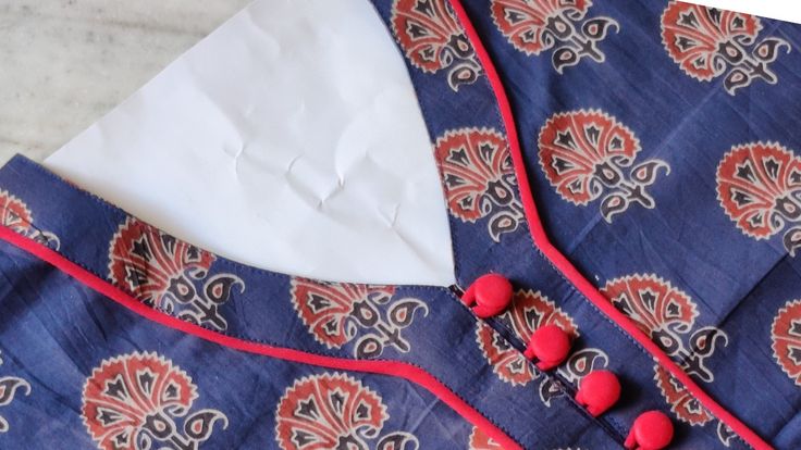 a blue and red patterned shirt with buttons on it