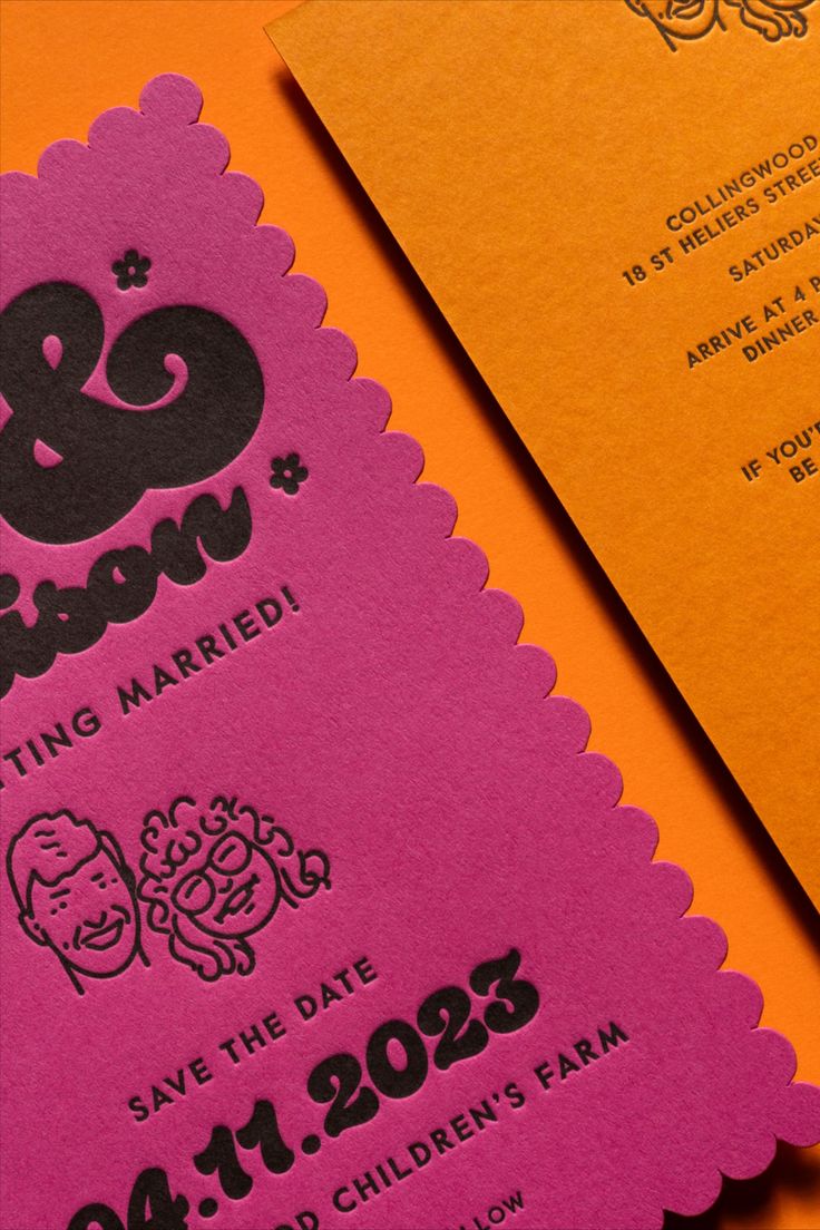 an orange and pink wedding card with the word & groom printed on it next to a yellow envelope