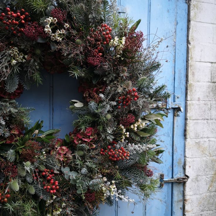 a blue door with a wreath on it