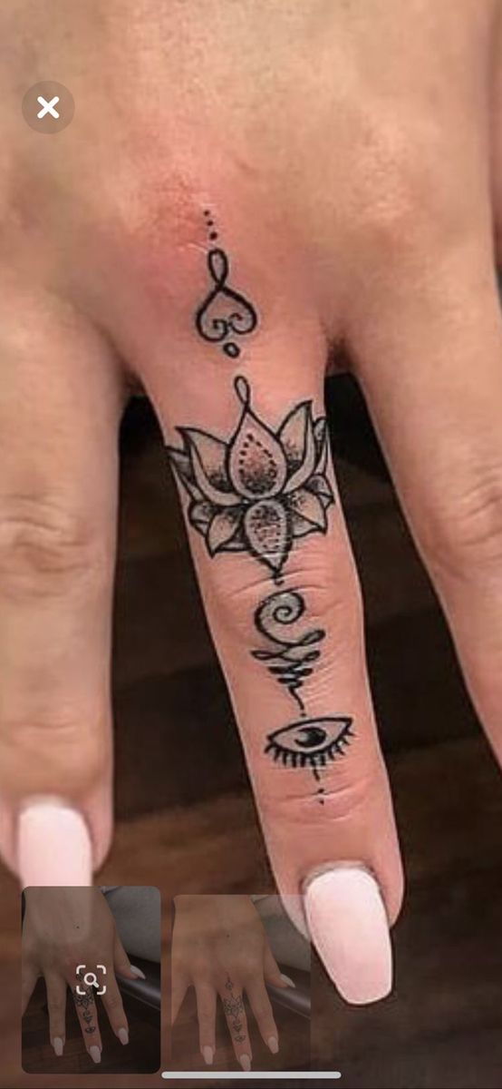 a woman's hand with a tattoo on it