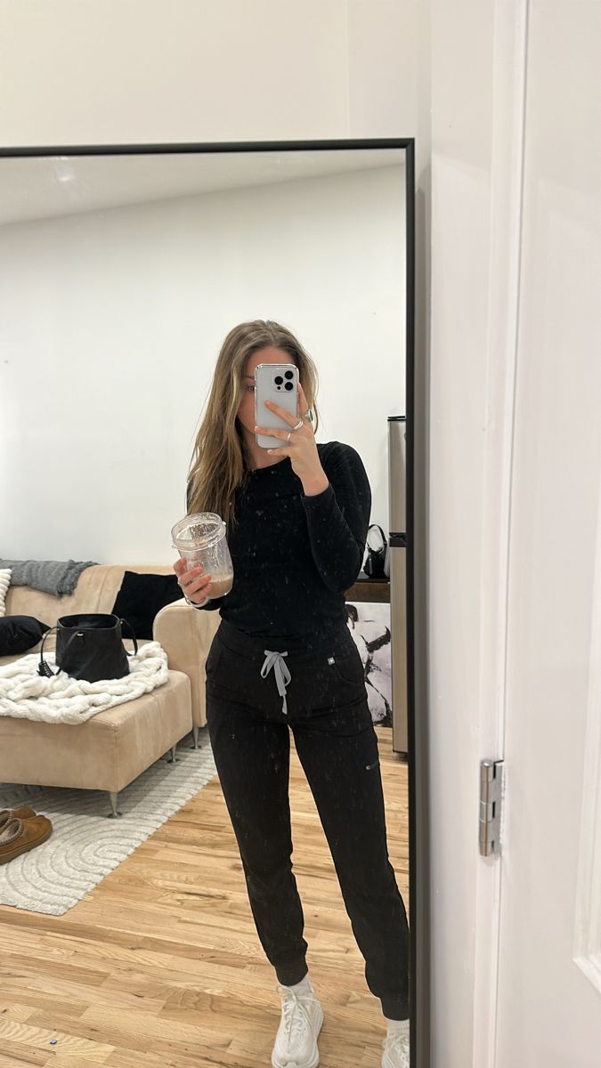 a woman taking a selfie in front of a mirror