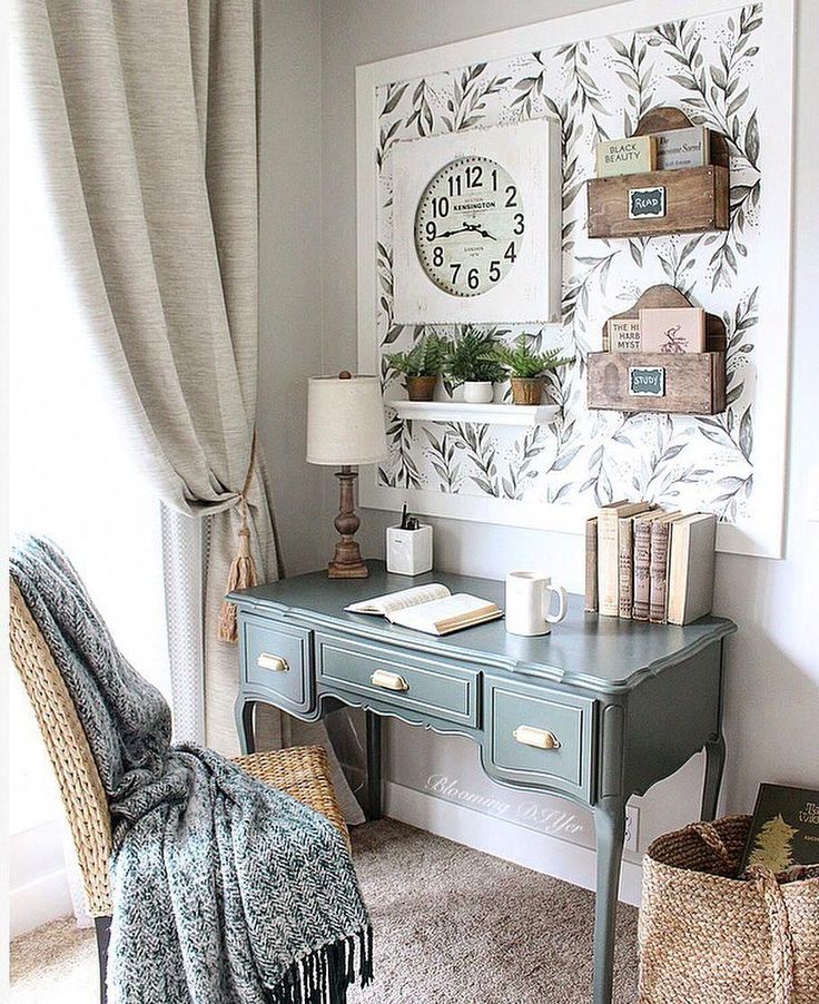 an instagram photo of a desk and chair in a room with a clock on the wall