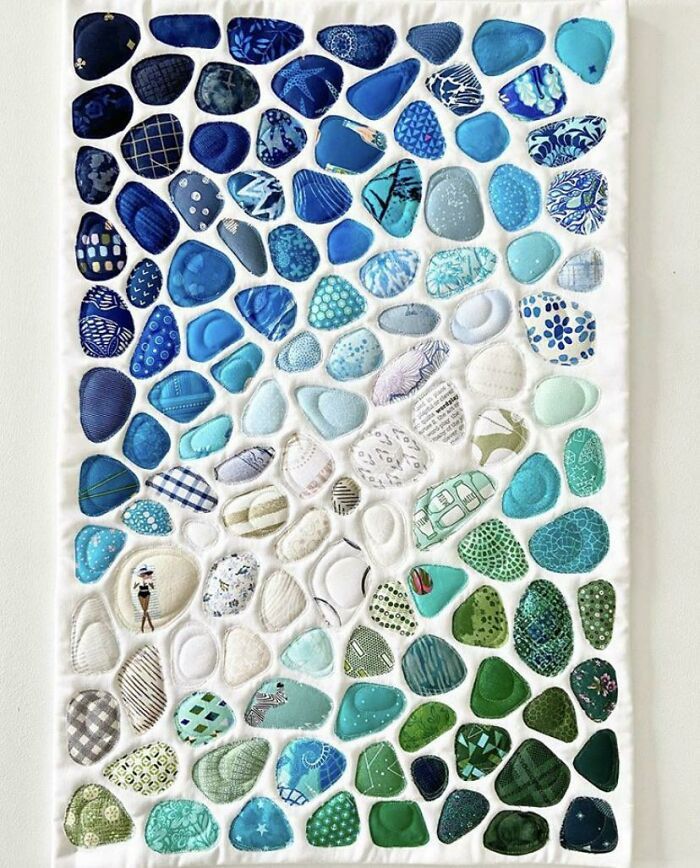 a piece of art made out of blue and green pebbles on a white background with text overlay that says how to make sea glass mosaics