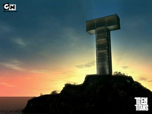 a large cross on top of a hill near the ocean