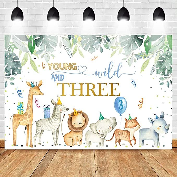 an animal themed birthday backdrop with the words young and wild three