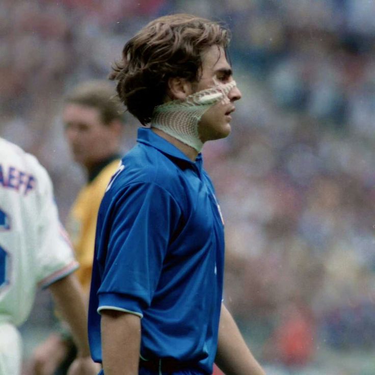 a soccer player wearing an inflatable mask on his face