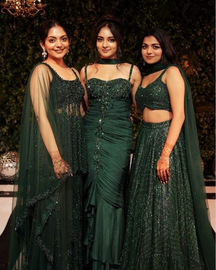 three women in green dresses standing next to each other