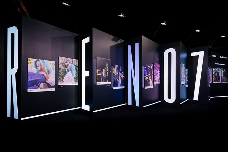 an exhibit with the words reino7 on it's sides and images projected in white letters