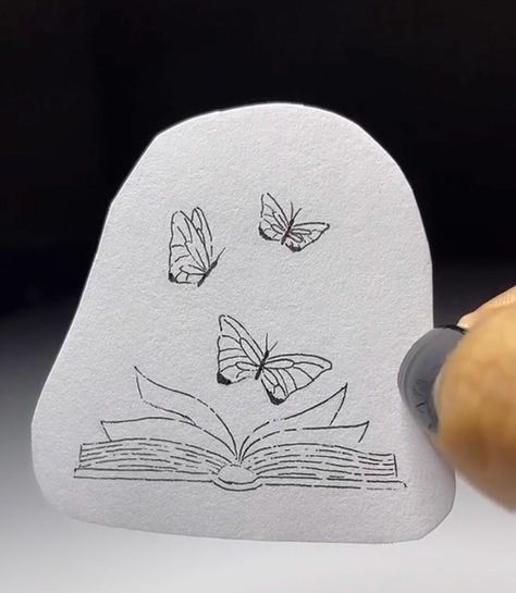 a book shaped like a pear with butterflies on it