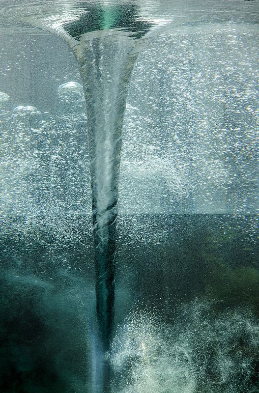 an underwater view of the ocean with bubbles and water coming from it's surface