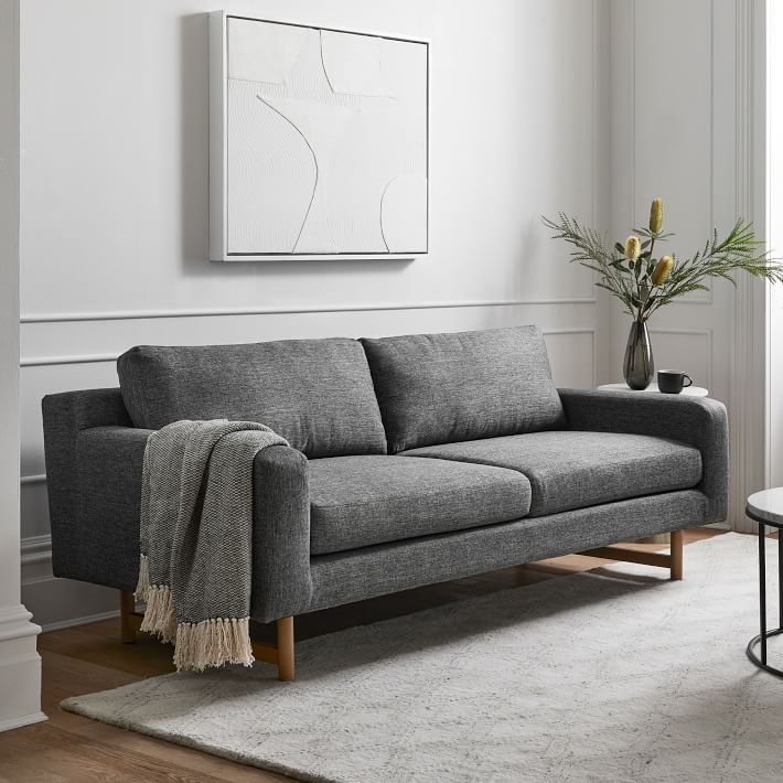 a living room with a gray couch and table