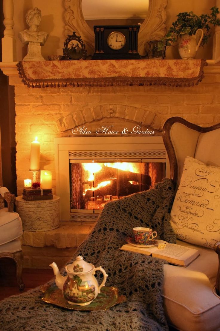 a living room filled with furniture and a fire place in front of a mantle topped with a clock