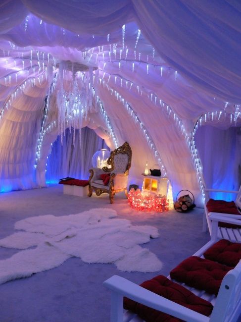 a room with white drapes and lights on the ceiling