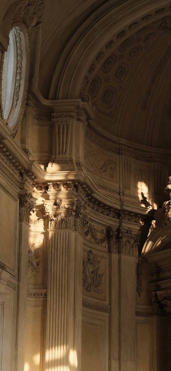 the sun is shining through the windows in this ornately decorated building with columns and arches