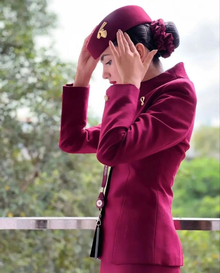 a woman in a red suit is holding her head