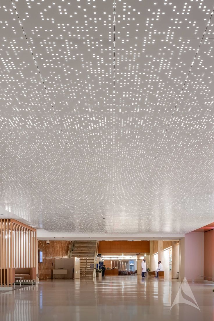 an empty lobby with lights on the ceiling