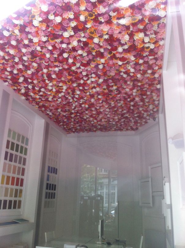 the ceiling is covered with many different colored flowers and colors are arranged on it's sides