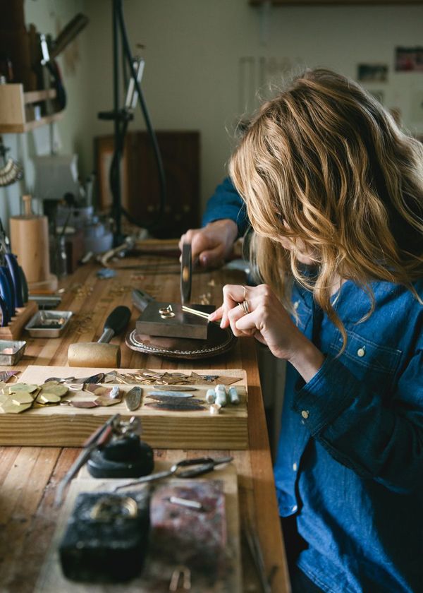 a woman is working on something in her workshop