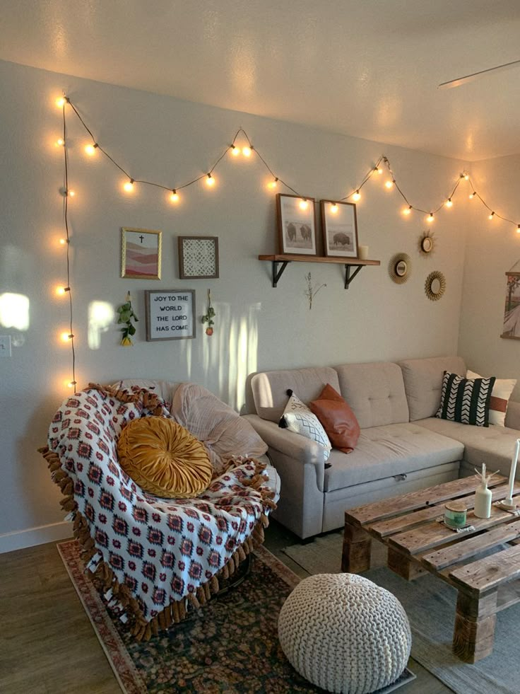 a living room filled with furniture and string lights