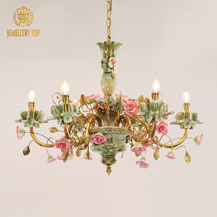 an ornate chandelier with pink flowers and green leaves