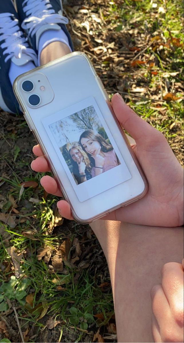 a person holding up a cell phone with an image on it