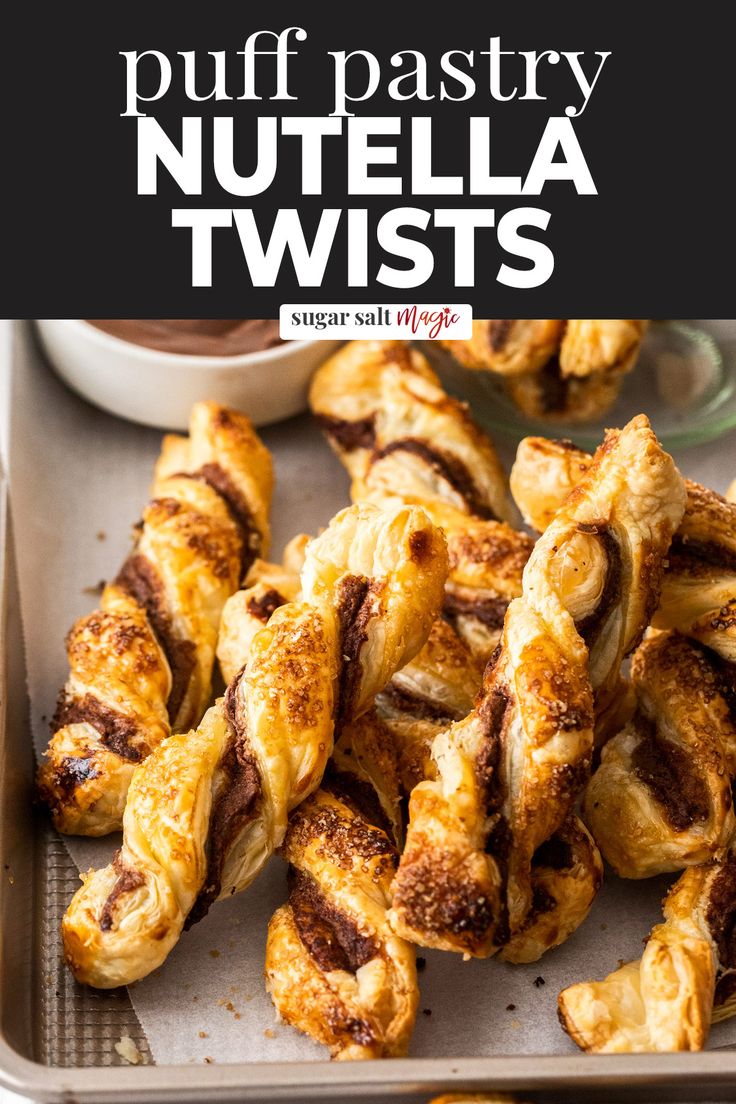 puff pastry nutella twists on a baking sheet with dipping sauce in the background and text overlay