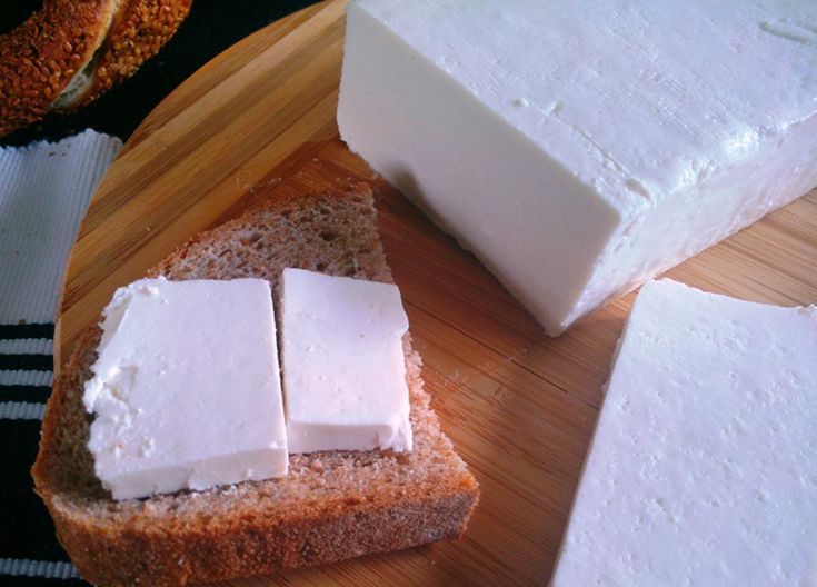 slices of bread and cheese on a cutting board