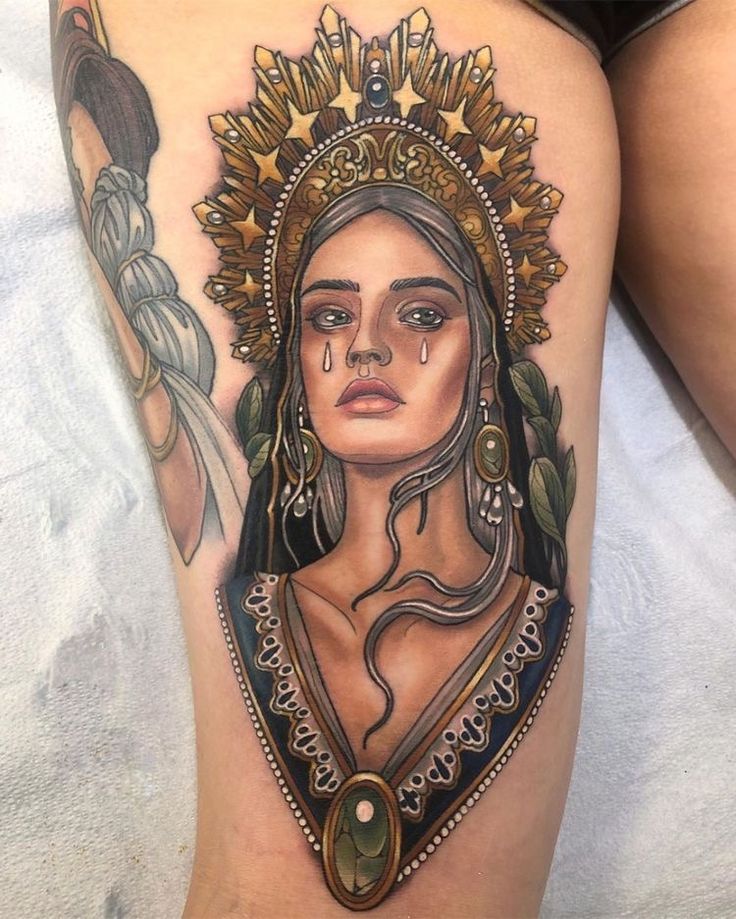 a woman's leg with tattoos on it and an image of a woman wearing a headdress