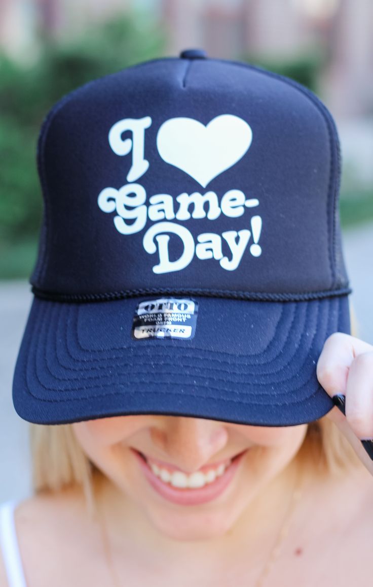 Get ready to score a fashion home run with our Love Game Days Trucker Hat! From the bleachers to the stadium, this trendy hat will keep you looking fly and showing team spirit! It's the ultimate game day accessory that can go with any outfit! Details: Soft, Trucker Hat 100% Polyester Features Front Graphic, White Lettering Color: Black One Size *OFFICIALLY LICENSED* Black OTTO Trucker Hat Adjustable Snap Back Comfortable Band on Inside for Forehead Baseball Cap For Tailgating During Baseball Season, Trendy Snapback Hat For Baseball Season, Game Day Team-colored Trucker Hat With Letter Print, Team-colored Trucker Hat With Letter Print For Game Day, Sporty Snapback Hat For Game Day, Game Day Hat For Baseball Season, Black Trucker Hat With Letter Print For Game Day, Trendy Hats For Baseball Season Sports Events, Adjustable Team-colored Trucker Hat For Game Day