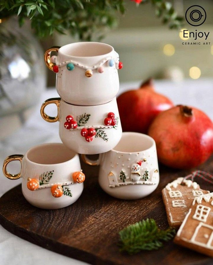 there are four cups on the tray with gingerbreads and apples in the background