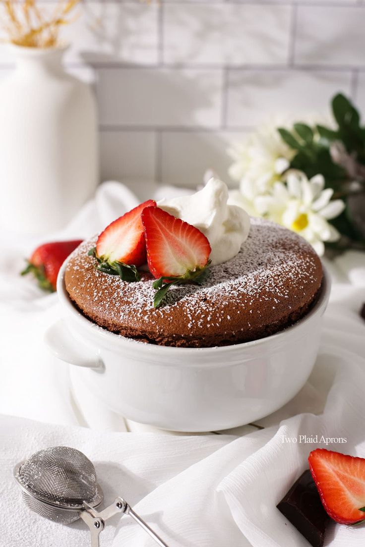 a chocolate cake with strawberries and whipped cream on top