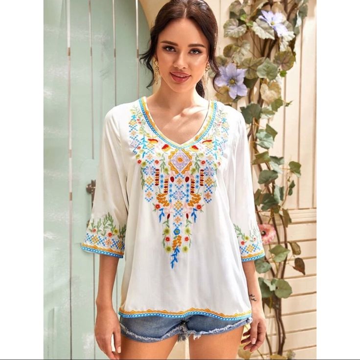 Boho Style Embroidered Tribal Tunic Style Blouse. Three Quarter Sleeve Length, Regular Sleeve, V Neck, Pullover Style, Regular Fit, Non-Stretch. Is Lined One Side Upto High Waist. 97% Rayon, 3% Polyester Perfect For Spring/ Summer Summer V-neck Top With Geometric Embroidery, Summer V-neck Blouse With Floral Embroidery, Bohemian V-neck Blouse With Multicolor Embroidery, Casual V-neck Blouse With Geometric Embroidery, Bohemian Multicolor Embroidered V-neck Top, Printed V-neck Blouse For Beach Season, Multicolor V-neck Top With Floral Embroidery, V-neck Tops With Floral Embroidery For Vacation, Summer Long Sleeve Top With Floral Embroidery