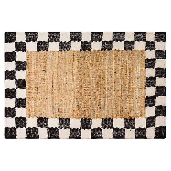 a black and white checkered rug with a tan border on the bottom, in front of a white background