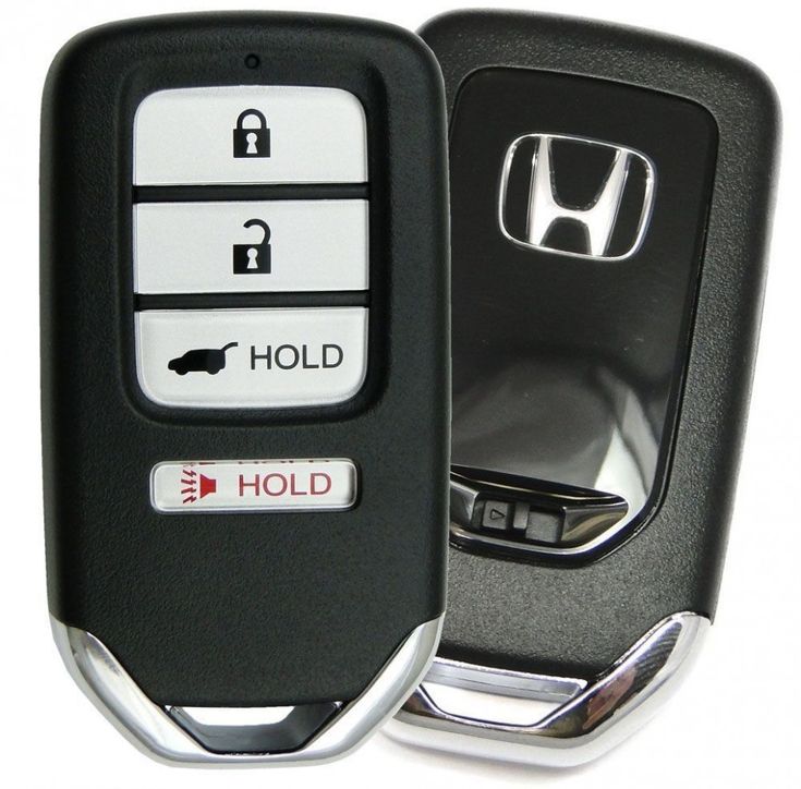 a car key that is sitting on top of a remote control case with the word hold written on it