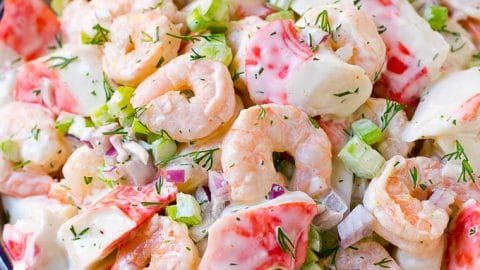 a salad with shrimp and celery in a bowl