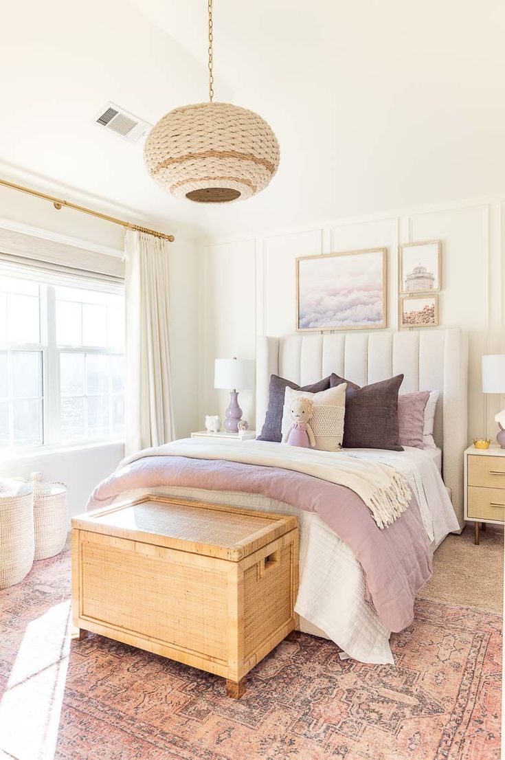 a bedroom with a bed, dressers and pictures on the wall above it's headboard