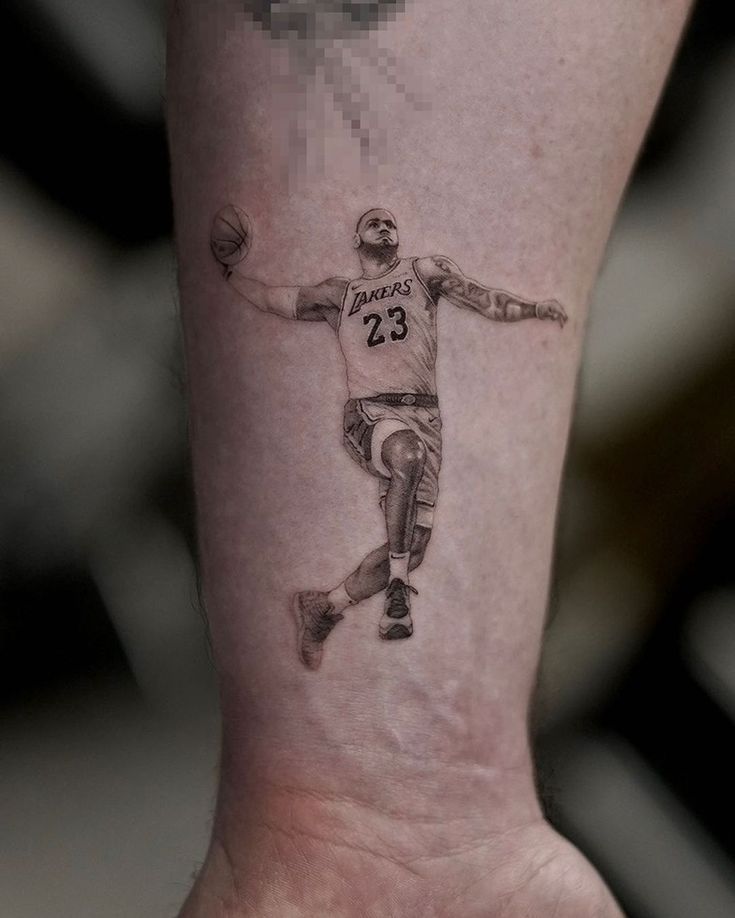 a man with a basketball tattoo on his leg