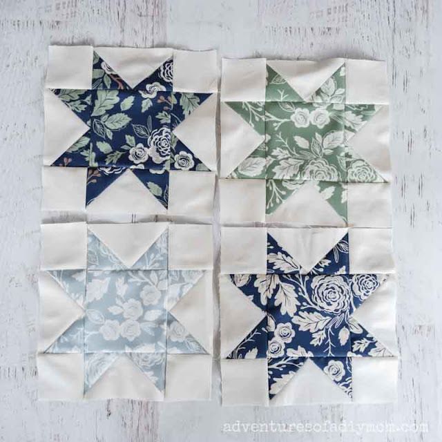 four star quilt blocks on a white table