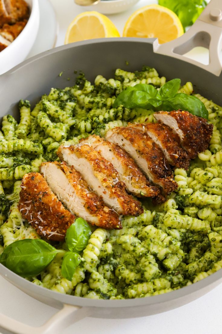 a pan filled with chicken and broccoli on top of a table