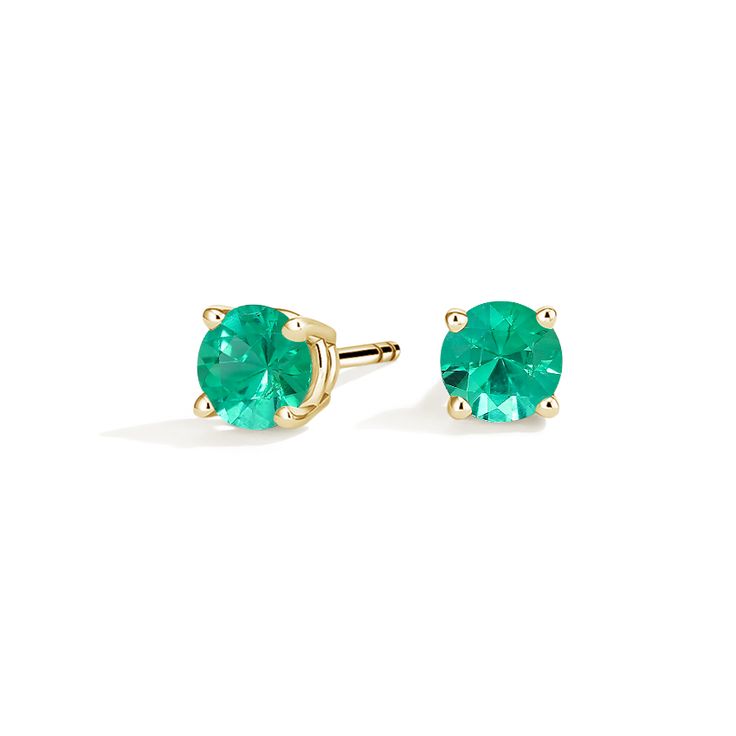 Solitaire Emerald Stud Ears - 18K Yellow Gold. These striking earrings feature deeply hued emeralds secured in classic four-prong basket settings with comfortable push back posts for pierced ears. Classic Round Cut Emerald Earrings, Classic Emerald Earrings With Prong Setting, Classic Emerald Earrings In Yellow Gold, Classic Yellow Gold Earrings With Emeralds, Classic Yellow Gold Emerald Earrings, Fortune Wheel, Emerald Stud Earrings, Yellow Gold Solitaire, Emerald Earrings Studs