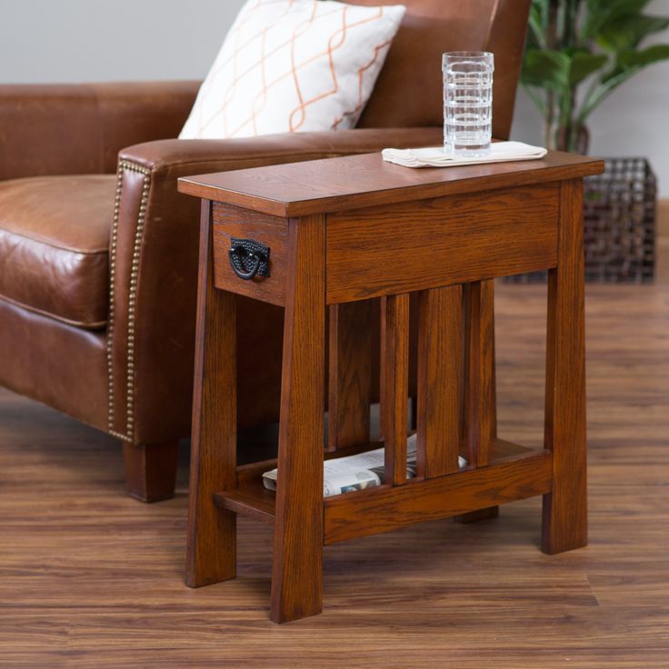 a small wooden table sitting on top of a hard wood floor next to a chair