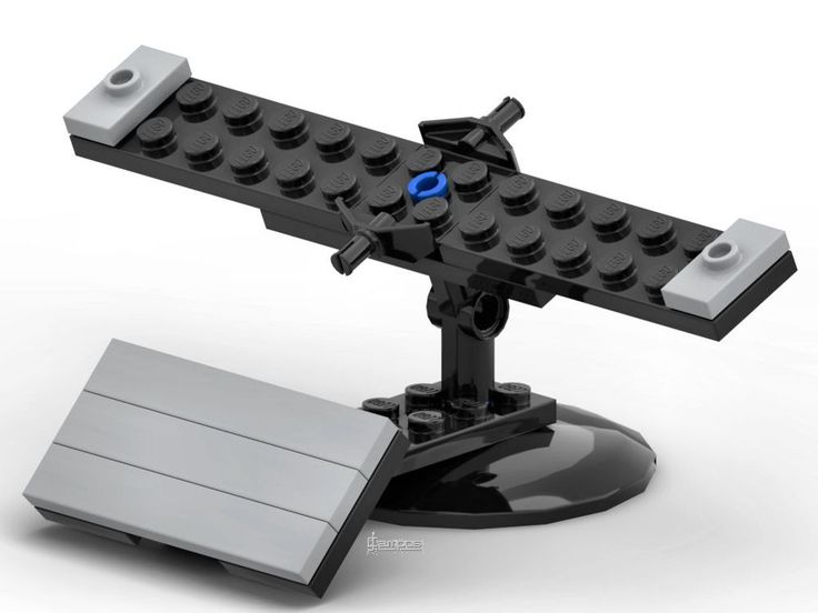 a lego airplane is sitting on top of a stand with a blue light in the center