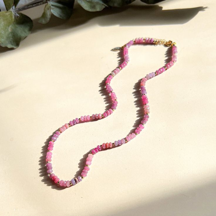 Dainty faceted Ruby beads strung with tiny gold spacers. Glowing with energy, these pink and red hued precious stones are a heart lifter. It is one of the four traditional main gemstones worn by nobility through the ages. Its power in history is unmatched. In Middle Ages Europe, wearing Rubies was believed to bring good health to the wearer. In Burma, where the stone is famously found, they went further and put them underneath the skin for protection. Mongol Emperor Kublai Khan is said to have t Single Strand Pink Opal Necklace With Round Beads, Pink Spiritual Necklace With Faceted Beads, Pink Spiritual Jewelry With Faceted Beads, Spiritual Pink Jewelry With Faceted Beads, Pink Faceted Beads Necklace As Gift, Pink Beaded Necklace With Natural Stones For Gift, Pink Faceted Beads Necklace For Gift, Pink Beaded Necklaces With Natural Stones As Gift, Pink Faceted Beads Necklaces For Gifts