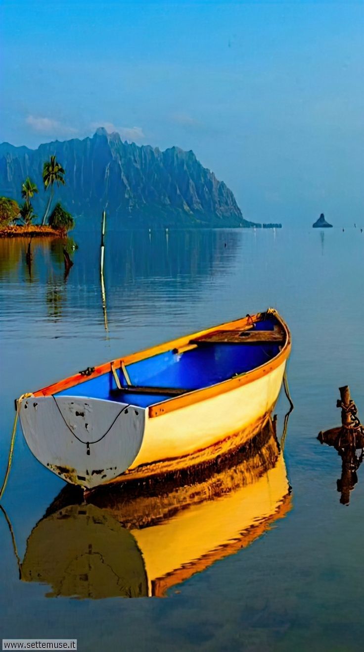 a small boat floating on top of a lake