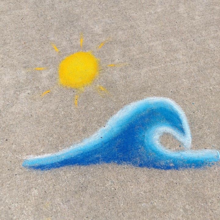 a drawing of a blue wave with a sun in the sky above it on sand